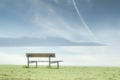 Lonely empty bench in open tranquil landscape by the sea for mindfulness and meditation
