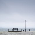 Lonely empty bench seat coastal sea peaceful quiet mindfulness scene view Royalty Free Stock Photo