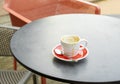 Lonely empty coffee cup with a spoon on a cafe table Royalty Free Stock Photo