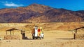 Lonely empty wild beach camping place with stone fireplaces, dry arid mountains, camper truck - Chile, Atacama region, Pan de