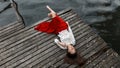 Lonely european girl in red skirt on the bridge