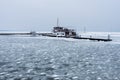 Lonely ferry in the frozen harbor