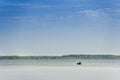 A lonely fisherman on the boat in the middle of the Svitiaz lake, Shatsk National Natural Park, Ukraine Royalty Free Stock Photo