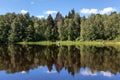 Lonely fisherman catching the fish from the wooden boat in the middle of lake bay, calm water at day time Royalty Free Stock Photo