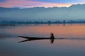 Lonely fisherman fishing at sunrise on a lake in Myanmar Royalty Free Stock Photo