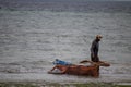 Lonely fisherman at the Mozambique sandy beach preparing boat to go for sailing and fishing Royalty Free Stock Photo