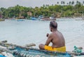 Lonely fisherman sitting on the fishing boat