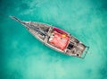 Lonely fishing boat in clean turquoise ocean, aerial photo