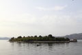 Lonely fishing boat docked in calm lake. wooden fishing boat in a still lake water. Royalty Free Stock Photo