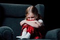 Lonely, frightened child sitting in armchair Royalty Free Stock Photo