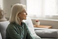 Lonely frustrated blonde older woman looking away with pointless look