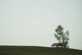 Lonely gazebo on the hill. summerhouse under tree standing alone in the field. solitude concept Royalty Free Stock Photo