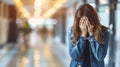 Lonely girl covering face in school corridor, student struggling with learning difficulties concept.