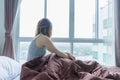 Lonely girl feeling sad looking out of window in rainy day Royalty Free Stock Photo