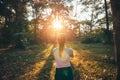 A girl hold leaves and standing in the forest and sunset Royalty Free Stock Photo