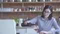 Lonely girl housewife pours wine in the kitchen