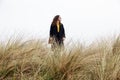 Girl rain sea wind portrait woman spring coat long hair curly mood shore beach dry grass sky