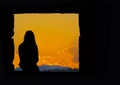 Lonely girl silhouette sitting at sunset