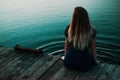 Lonely girl sitting in fornt of bog lake Royalty Free Stock Photo