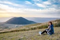 Lonely girl sitting next to Komezuka of Mount Aso Aso-san Royalty Free Stock Photo