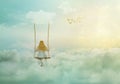 Lonely little girl sitting on the swing above clouds; fantasy/solitude/surreal background with copy space