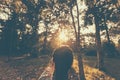 Lonely girl standing in the forest and sunrise in the morning. Royalty Free Stock Photo