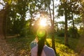 Lonely girl standing in the forest and sunset with sun flare Royalty Free Stock Photo