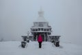 Lonely girl standing on Radhost mountain looking to Chapel of St. Cyril and Methodius,Beskids,Czech republic.Silhouette of man in Royalty Free Stock Photo