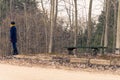 Lonely girl stands at the bus stop. Solitude