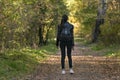 Lonely girl stands in the park and looks up. Walk alone. Back view Royalty Free Stock Photo