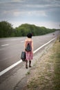 Lonely girl with suitcase Royalty Free Stock Photo