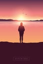 Lonely girl at sunrise by the lake with mountain view Royalty Free Stock Photo