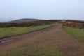 A lonely gravel track leads across the Quantock Hills. The winter sky is cloudy and overcast Royalty Free Stock Photo