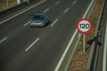 Lonely grey car on highway and SPEED LIMIT signpost in Madrid Royalty Free Stock Photo