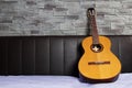 Lonely guitar standing ob bed Royalty Free Stock Photo