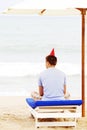 Lonely guy in hat on beach from behind Royalty Free Stock Photo