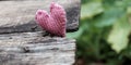 Lonely heart on wooden background