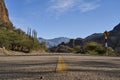 Lonely highway with yellow middle line in a beautiful and arid desert landscape. Royalty Free Stock Photo