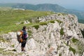 Lonely hiker admires the scenery of the spring mountains