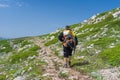 Lonely hiker walks through Chatyr-Dah mountainous massif in Crimean mountains