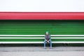 Lonely hipster male sitting on a bench