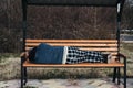 lonely homeless elderly old senior Caucasian man lying sleeping on park bench in autumn