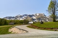 A lonely house in a green meadow against the backdrop of a mountain with snow. Montenegro Royalty Free Stock Photo