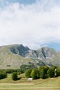 Lonely house in a green valley at the foot of the mountains Royalty Free Stock Photo