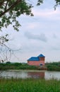 Lonely house on the lake, pink house with blue roof, June 11, 2018, Kaliningrad region, Russia