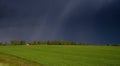 A lonely house in the middle of a green field and a stormy sky Royalty Free Stock Photo