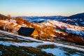 Lonely house standing on mountain slope. Melting snow in spring Royalty Free Stock Photo