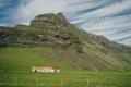 Lonely icelandic house by the mountain in iceland. Natural Iceland travel landscape. Royalty Free Stock Photo
