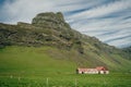 Lonely icelandic house by the mountain in iceland. Natural Iceland travel landscape. Royalty Free Stock Photo