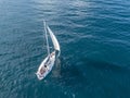 Lonely isolated yacht under the sail with tall mast going in still sea aerial top view ÃÂ¼